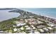 Waterfront community with lush landscaping and private beach access offers an ideal coastal lifestyle at 534 Sutton Pl, Longboat Key, FL 34228