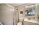 A clean, bright bathroom with a frosted glass shower and a large vanity mirror at 534 Sutton Pl, Longboat Key, FL 34228