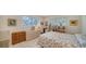 Cozy bedroom featuring tiled flooring, two windows, and dresser with woven drawers at 534 Sutton Pl, Longboat Key, FL 34228