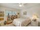 Cozy bedroom featuring tiled flooring, one window, personal library, and nightstand with lamp at 534 Sutton Pl, Longboat Key, FL 34228