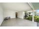 Open carport featuring concrete floors, neutral wall, and black door at 534 Sutton Pl, Longboat Key, FL 34228