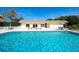 Enjoy a refreshing swim in the sparkling community pool, complete with lounge chairs and seating areas at 534 Sutton Pl, Longboat Key, FL 34228