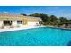 Enjoy a refreshing swim in the sparkling community pool, complete with lounge chairs and seating areas at 534 Sutton Pl, Longboat Key, FL 34228