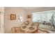 Dining area with rattan chairs, leading to a sunroom with lots of light at 534 Sutton Pl, Longboat Key, FL 34228