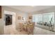 Bright dining area featuring a tile floor with seating for four at 534 Sutton Pl, Longboat Key, FL 34228