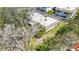 An aerial view of a condo/townhouse showcasing mature trees and a well-maintained lawn at 534 Sutton Pl, Longboat Key, FL 34228