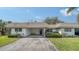 Charming single-story home featuring a covered carport and landscaped yard at 534 Sutton Pl, Longboat Key, FL 34228