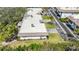 Aerial view of a condo/townhouse exterior showing mature trees, landscaping, and an asphalt driveway at 534 Sutton Pl, Longboat Key, FL 34228