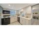 Efficient kitchen featuring tile floors, white cabinets, and black appliances at 534 Sutton Pl, Longboat Key, FL 34228