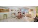 Comfortable living room with white sofa, tile floors, and a bright window at 534 Sutton Pl, Longboat Key, FL 34228