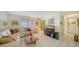 Cozy living room with tile floors, white sofa, and flatscreen television at 534 Sutton Pl, Longboat Key, FL 34228
