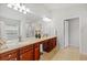 Primary bathroom with double vanity, dark wood cabinets, and a large mirror at 5342 98Th E Ave, Parrish, FL 34219