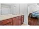 Bright bathroom featuring vanity with cabinets, a neutral counter and a view to the bedroom at 5342 98Th E Ave, Parrish, FL 34219