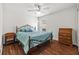 Bedroom features hardwood floors and an ornate wrought iron bed frame with bright blue comforter at 5342 98Th E Ave, Parrish, FL 34219