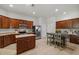 Kitchen with stainless steel appliances, wooden cabinets, an island, and an eat in table with chairs at 5342 98Th E Ave, Parrish, FL 34219