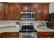Close up of kitchen appliances including microwave, oven, and stove top at 5342 98Th E Ave, Parrish, FL 34219