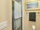 Neutral-toned bathroom featuring artwork, a towel rack, and a shower with a glass door at 5614 Garden Lakes Dr, Bradenton, FL 34203