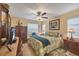 Cozy bedroom showcasing a ceiling fan, window, and furnishings, with an inviting, warm color scheme at 5614 Garden Lakes Dr, Bradenton, FL 34203