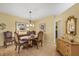 Elegant dining room featuring a classic chandelier, a wood table with chairs, and decorative accents at 5614 Garden Lakes Dr, Bradenton, FL 34203
