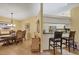 Open dining room featuring tile floors, a decorative light fixture, and adjacent kitchen bar seating at 5614 Garden Lakes Dr, Bradenton, FL 34203