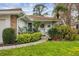 Inviting home featuring a landscaped front entrance, brick accents, and a decorative front door at 5614 Garden Lakes Dr, Bradenton, FL 34203