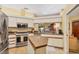 Bright kitchen with stainless steel appliances, a skylight, white cabinets, and tiled floors at 5614 Garden Lakes Dr, Bradenton, FL 34203