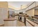 Well-lit kitchen with white cabinets, stainless steel appliances, and a convenient island at 5614 Garden Lakes Dr, Bradenton, FL 34203