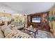 Cozy living room featuring comfortable seating, a decorative rug, and a large entertainment center at 5614 Garden Lakes Dr, Bradenton, FL 34203