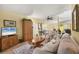 Open concept living room with large windows, comfortable seating, and easy access to other rooms at 5614 Garden Lakes Dr, Bradenton, FL 34203