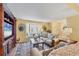 Bright living room showcasing neutral furniture, an entertainment center, and a large bay window at 5614 Garden Lakes Dr, Bradenton, FL 34203