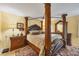 Spacious main bedroom featuring a decorative four-poster bed and elegant furniture at 5614 Garden Lakes Dr, Bradenton, FL 34203
