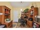 Home office with built-in wooden shelving, a desk, and natural light at 5614 Garden Lakes Dr, Bradenton, FL 34203