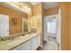 Bathroom features a double sink vanity with granite countertops and a walk in shower at 5700 Bentgrass Dr # 209, Sarasota, FL 34235