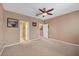 Spacious bedroom features neutral paint, carpeted floors, and multiple doorways at 5700 Bentgrass Dr # 209, Sarasota, FL 34235