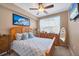 Cozy bedroom with a ceiling fan, dresser, and a comfortable bed with patterned bedding at 5700 Bentgrass Dr # 209, Sarasota, FL 34235