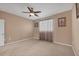 Spacious bedroom features neutral paint, carpeted floors, a ceiling fan, and a window at 5700 Bentgrass Dr # 209, Sarasota, FL 34235