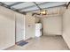 Garage features a white refrigerator and an entryway door at 5700 Bentgrass Dr # 209, Sarasota, FL 34235