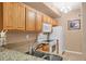 Charming kitchen showcases wood cabinets, granite counters, and white appliances at 5700 Bentgrass Dr # 209, Sarasota, FL 34235