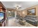 Cozy living room features tile flooring, comfortable seating, and a sliding glass door to the outdoors at 5700 Bentgrass Dr # 209, Sarasota, FL 34235