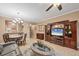 Living room featuring tile flooring, a ceiling fan, and an adjacent dining area for easy entertaining at 5700 Bentgrass Dr # 209, Sarasota, FL 34235