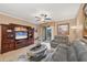 Living room showcasing tile floors, a ceiling fan, and sliding doors leading to a screened lanai at 5700 Bentgrass Dr # 209, Sarasota, FL 34235