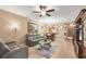 Open-concept living room with tile flooring, ceiling fan, and an adjacent dining area at 5700 Bentgrass Dr # 209, Sarasota, FL 34235