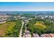 An aerial view of a serene neighborhood boasting lush greenery, complemented by ponds and charming single-Gathering homes at 6156 41St E St, Bradenton, FL 34203
