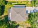 An aerial rooftop view reveals a brown shingle roof and a screened-in patio at 6156 41St E St, Bradenton, FL 34203