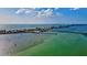 An aerial view captures the coastal beauty, revealing a bridge connecting a waterfront community surrounded by tranquil ocean views at 6156 41St E St, Bradenton, FL 34203