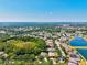 An aerial view of a neighborhood featuring lush trees, scenic ponds and beautiful single-Gathering homes on a sunny day at 6156 41St E St, Bradenton, FL 34203