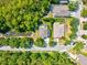 An aerial view showcases a backyard with a tree-lined creek and lush landscaping at 6156 41St E St, Bradenton, FL 34203
