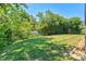 Well-maintained backyard with a lush lawn, bordered by mature trees and shrubs for added privacy at 6156 41St E St, Bradenton, FL 34203
