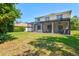 Expansive backyard with a covered patio and lush lawn, ideal for outdoor activities and relaxation at 6156 41St E St, Bradenton, FL 34203