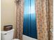 Bathtub and toilet with palm tree print curtain, providing privacy and style at 6156 41St E St, Bradenton, FL 34203